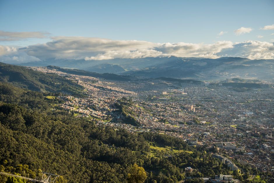 colombia — Aerial shot of Bogotá, Colombia, showcasing cityscape and surrounding lush mountains.