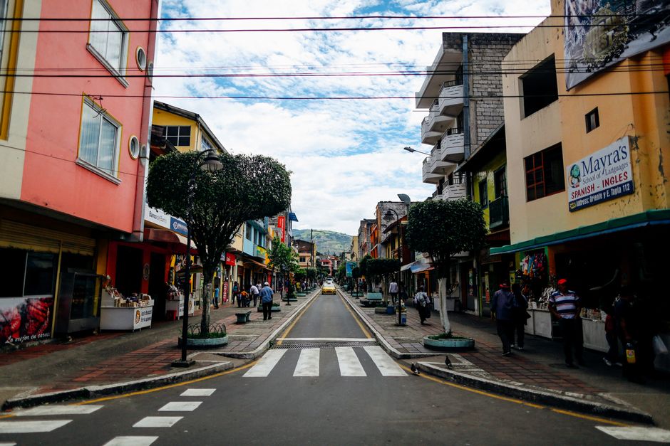 ecuador — Lively street view in an Ecuadorian town with shops, pedestrians, and urban architecture.