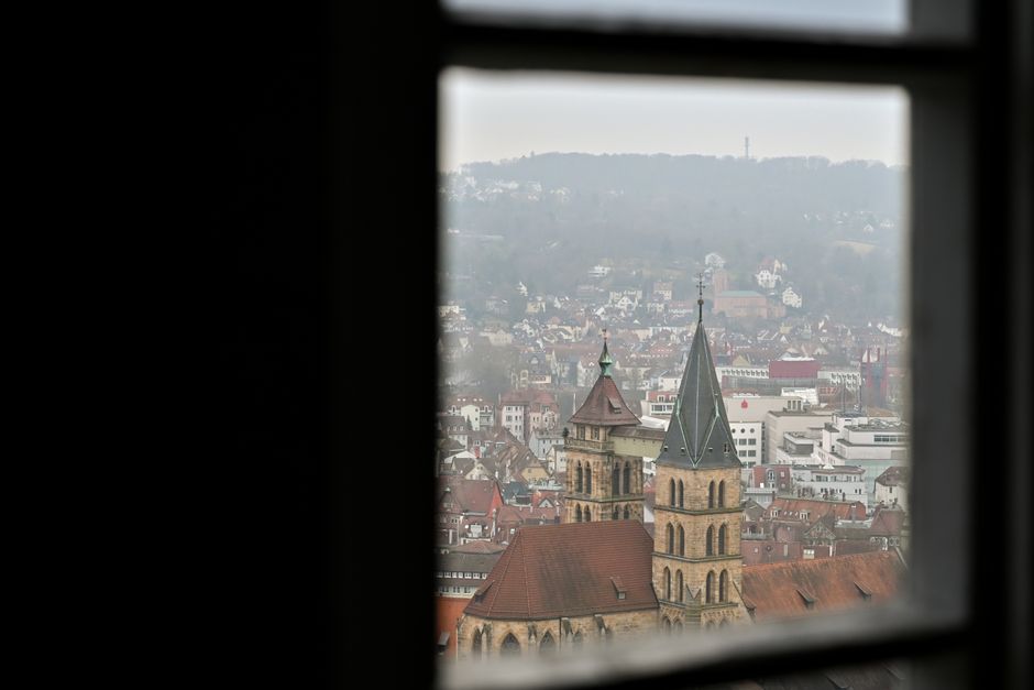 Cityscape of Stuttgart viewed through a window with a focus on historical architecture.