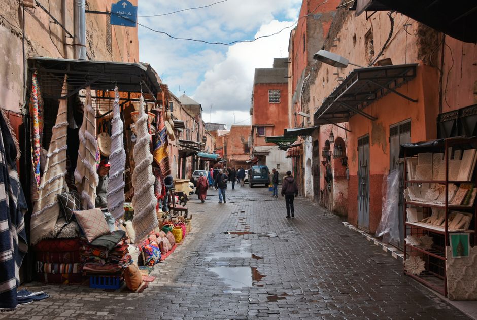 Explore the bustling streets of Marrakech with vibrant fabrics and traditional architecture in this lively mar