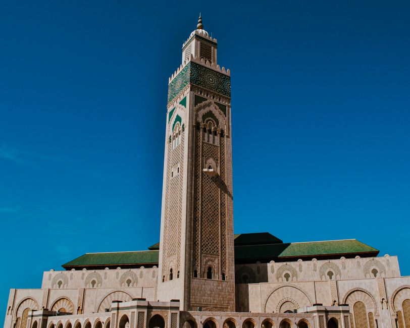 morocco — Stunning view of the Hassan II Mosque's intricate design with a clear blue sky in Casablanca.