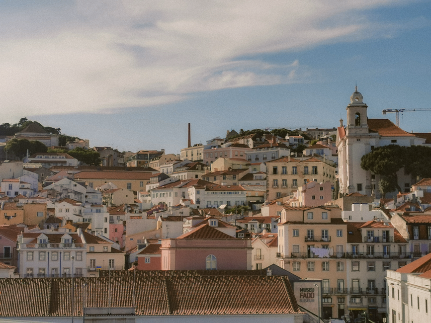 portugal — Aerial view of Lisbon's charming historic architecture under a bright sky.