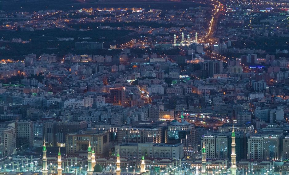 Aerial view of contemporary big metropolis illuminated with glowing city lights at night