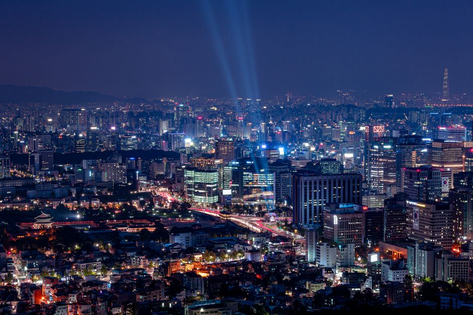 south korea — A breathtaking aerial view of a vibrant city illuminated at night.