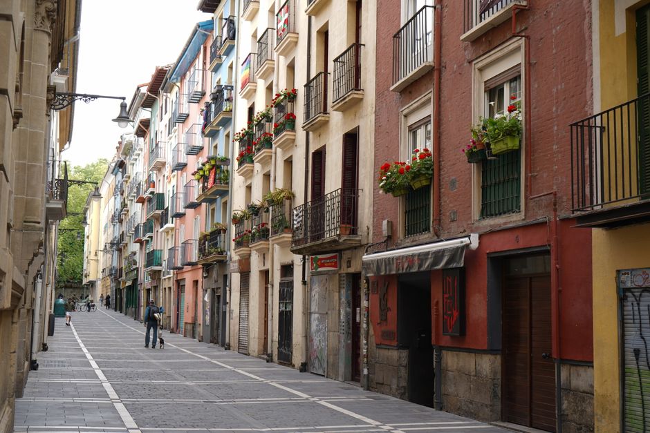 spain — Explore a vibrant street in Pamplona, Spain, featuring a row of colorful residential buildings.